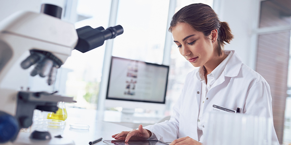 Woman in a lab looking at a tablet